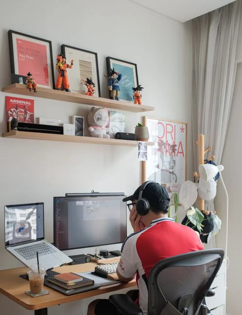 Dual monitors on a desk, showcasing web design in a modern office setting.